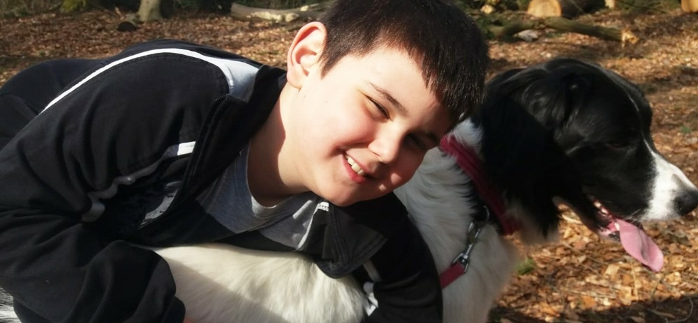 Junge umarmt einen Hund